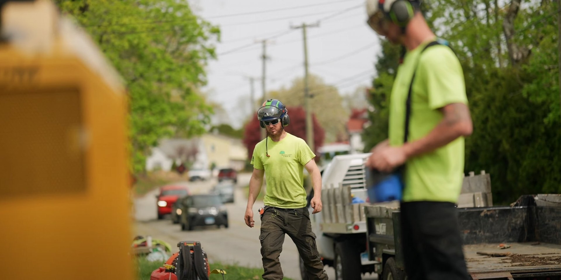 Lawrence Tree Services professional crew in action Professional tree service crew with safety equipment working on residential property